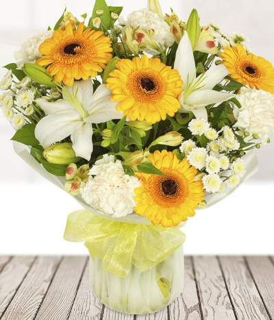 Brightside - White and yellow flowers are the match made in flower heaven. Yellow gerberas and white lilies are the key flowers in the is sunshine filled bouquet. Finished off with alstroemeria and carnations.