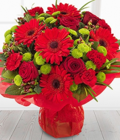 Ruby Red - Ruby red Roses, Gerberas and Carnations simply zing against the glorious green Spray Chrysanthemums. With a touch of Hypericum and a flourish of Palm, this bouquet really does stand out from the crowd.