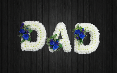 Atlante - DAD105 - DAD tribute blue and white colours. Flowers include roses, chrysanthemums, statice and foilage on white chrysanthemums base. Price: Standard (without ribbon) - Deluxe (with ribbon). Stand frame included.