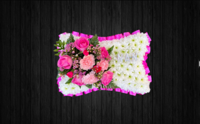 Cinderella - PIL63 - Lovely Pillow tribute in shades of pinks and whites using roses, carnations, spray carnations, wax flower, leather leaf on white chrysanthemums base and pink ribbon edge. Silver letters are at additional 70p per letter.