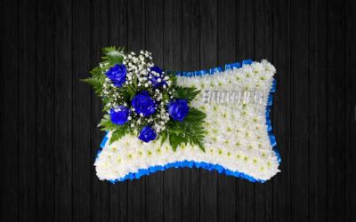 Blue Diamond - PIL66 - Blue and white Pillow tribute using roses, gypsophilia, leather leaf on white chrysanthemums base and blue ribbon edge. Silver lettering additional 70p per letter.