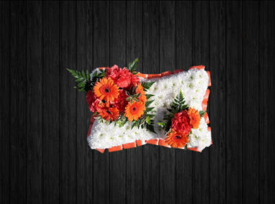 Orange Shades - PIL42 - Orange and white pillow tribute includes germin, carnations, leather leaf on a white euro chrysanthemums base finished off with orange ribbon edge.