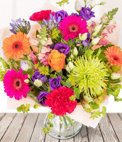 Bold Blooms - A mixture of a whole bunch of blooms from oranges roses, green chrysanthemum, orange germini's, cerise carnations, and foliage.