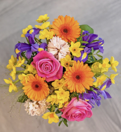 Spring Morning - This seasonal bouquet is filled with colourful germini, delicate roses, bold iris and seasonal foliage to complement.