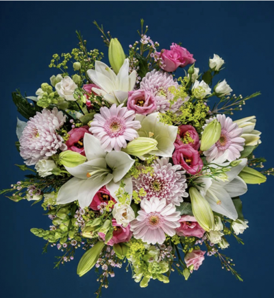Delicate Pastel Shades - Who doesn't love pastel shades? This pretty bouquet is filled with pale pink chrysanthemums and germini, cream lilies, white roses and seasonal foliage.