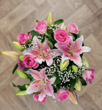 Mothers Hug - This stunning bouquet features pink roses and scented oriental lilies, complemented by a touch of gypsophila.