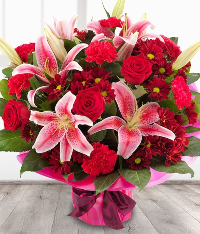 Get Lucky - An incredibly romantic and simply stunning rich red Rose & pink Lily flower bouquet with deep red Spray Chrysanthemums and bold Carnation blooms.