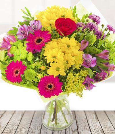 Just Colourful - Just Colourful contains yellow daisy spray chrysanthemum, purple alstroemeria, cerise germini and a rose, finished off with seasonal foliage.