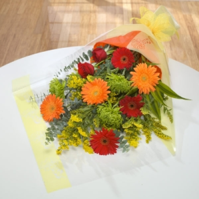 Heart On Fire - Glowing orange and red Gerbera and red Roses create a warm arrangement to brighten somebody's day.