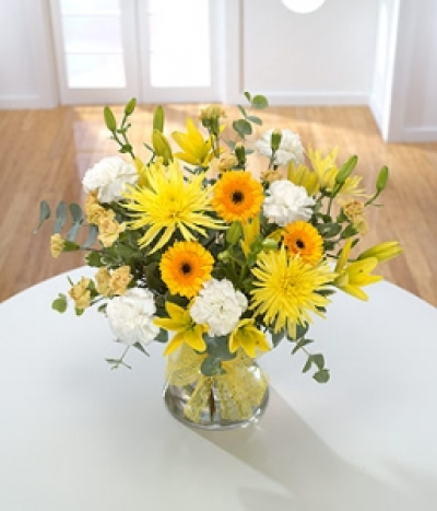 Bright Bouquet - Send somebody a ray of sunshine! Yellow Chrysanthemums and Lilies mixed with golden spray Carnations and Germini. A bright and cheerful arrangement for any occasion. Hand-Tie in water.