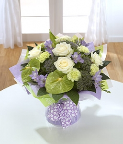Aquamarine - This attractive hand-tied features green Anthuriums, white Roses and scented Freesia.