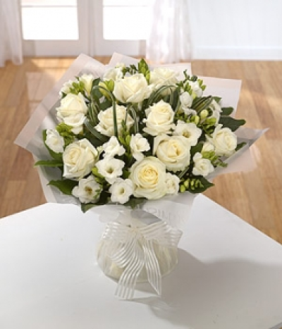 Innocence - Pure and innocent: simply white Roses and Freesia with pretty looped grass.
