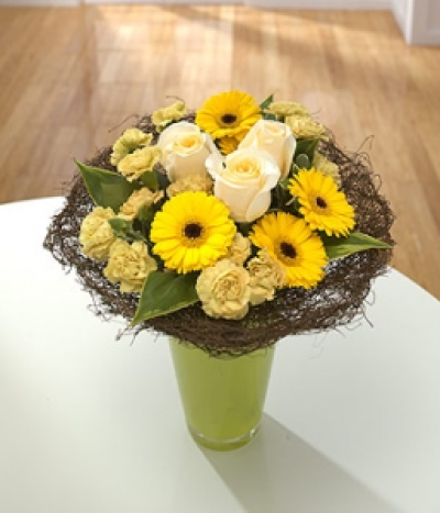 Sunburst - Roses, Germini and golden spray Chrysanthemums sit in this attractive, natural twig collar in a vase.