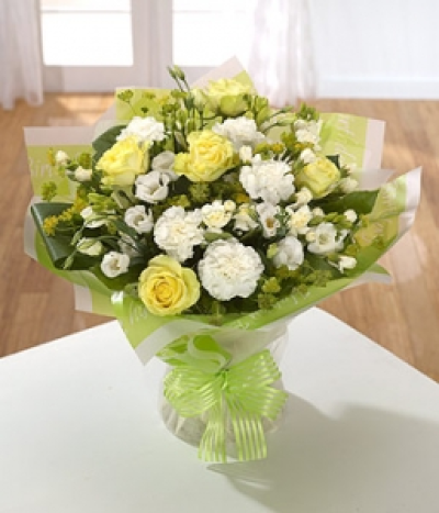 Cherished - Delicate lemon Roses, cream spray Carnations and perfumed Freesia highlighted with frilly white Carnations.