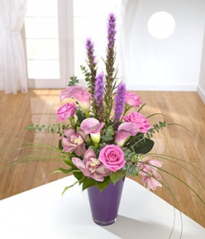 Fusion - Elegant pink Cymbidium Orchids and Calla Lilies are given a quintessentially English touch with pink Roses and purple Liatris.