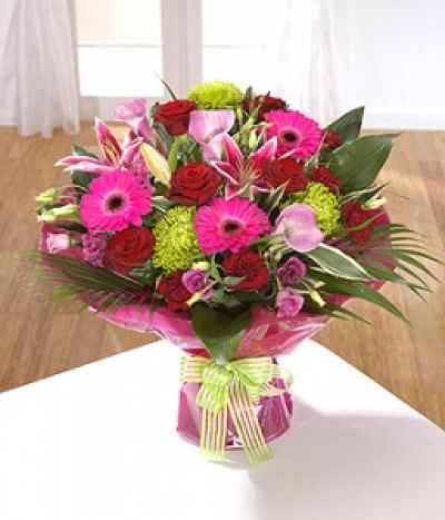 Bolero - A seductive collection of flowers starring deep velvet Roses and fragrant Lilies. This is bound to capture anyone's heart.