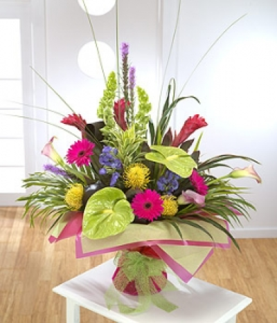 Colour Explosion - An elaborate design with tropical flowers starring Anthurium, Gerbera and Calla Lilies and exquisite foliage.