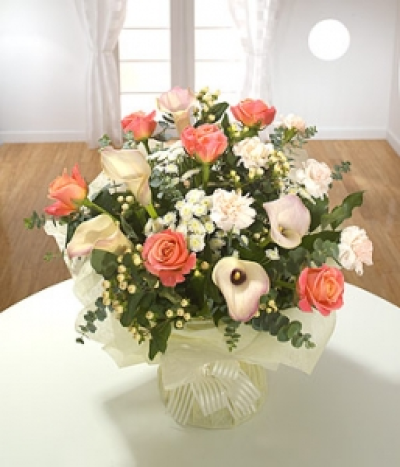 Egyptian Sun - A sumptuous hand-tied aqua pack with Roses, Calla Lilies and peach Carnations. Chrysanthemums and shiny Hypericum berries complete the picture.
