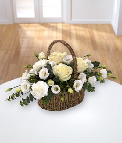 Sentiments Basket - An Oval basket arrangement of white sympathy flowers, including Roses and carnations.
