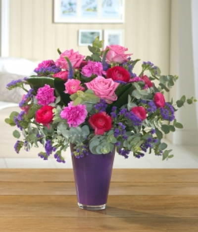 A Bright Extravaganza - A bright array of sweet-smelling Roses with Carnations and purple Veronica.,