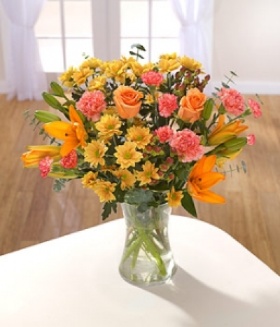 Arabian Sunset - Orange Lilies, Roses, Carnations and bronze spray Chrysanthemums make this a very desirable and rich bouquet. Ideal for those who like to arrange flowers. Hand-Tie in water.