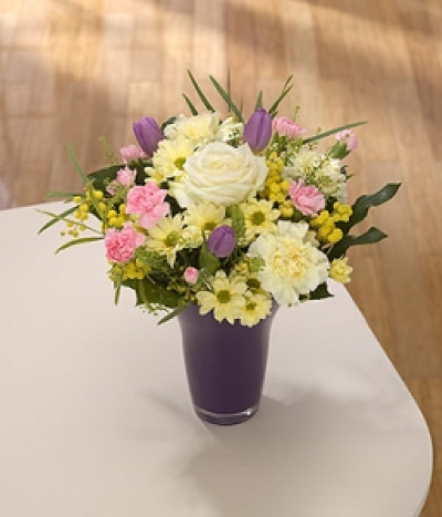 Pretty Pastels - The soft and pretty pastel colours of this vase arrangement reflect the beauty of Spring. Lavender Tulips, cream Roses, pale blue Hyacinths and pink spray Carnations.