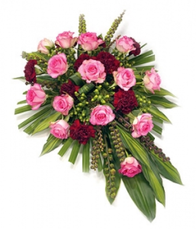 Single Ended Rosa Spray - A beautiful single ended spray of pink roses & red Carnations combined with variegated foliage and Palm Leaves. Size: 53cm (21"). Available in any colours.