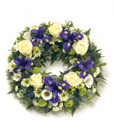 Traditional Round Wreath - Open round wreath with natural foliage edge including Iris, Roses, Chrysanthemums and complementary foliage. Size: Diameter - 31cm (12").