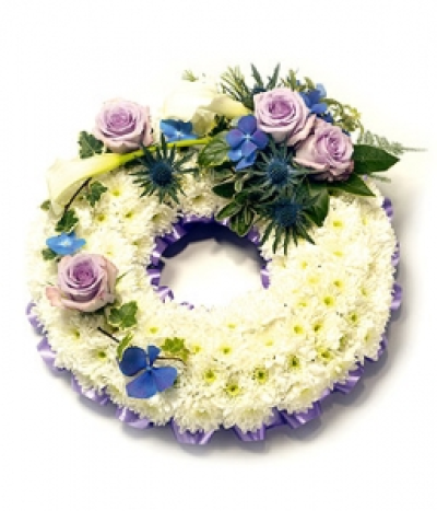 Open Round Wreath - Based white Chrysanthemum open round wreath including Roses, Hydrangea and Eryngium with complementary foliage. Size: Diameter - 31cm (12").