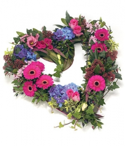 Contemporary Open Heart - Textured open heart shape tribute in shades of pink and blue, including Roses, Gerbera, Hydrangea, Eustoma and complementary foliage edge. Size: Height - 43cm (17") Width - 43cm (17").