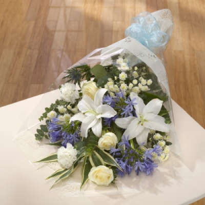 Blue Sea - This appealing bouquet features white Lilies, Roses and Chrysanthemums, highlighted with blue Agapanthus and Eryngium.