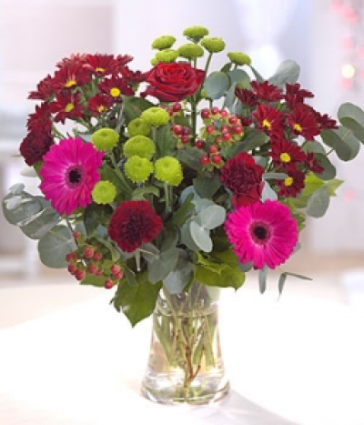 My Love - Romantic reds and burgundy are incorporated into this romantic bouquet including a red Rose, Gerberas, Carnations and Chrysanthemums. Hand-Tie in water.