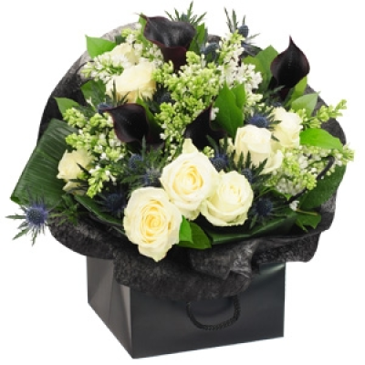 Haute Coture - This dramatic bouquet offers real flair with sumptuous avalanche roses, elegant black calla lilies and dainty bouvardia flower. Arranged with thistles and framed with folded aspidistra, Haute Couture is finished with a black weave and presentation bag for a contemporary feel. Perfect for anyone, whether male or female, and whatever the special occasion. Price: Standard £50. 00 Luxury £75. 00 Superior £100. 00+