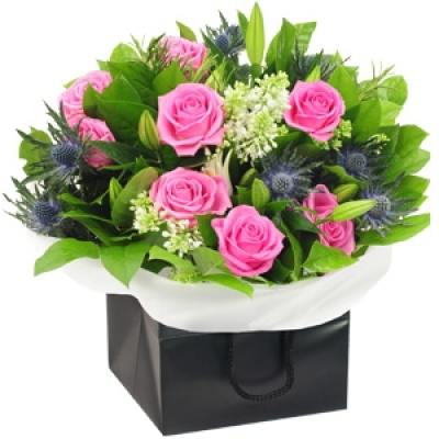 Pink Taffeta - Wonderful white lilies, pastel pink roses and eye-catching blue thistles make up the pretty palette of this bouquet. The addition of bouvardia and fresh rosemary foliage make for a joy to the senses, with everything carefully finished with a luxurious wrap and pretty presentation bag. A lovely bouquet, ideal for a myriad of special occasions or events. Price: Standard £50. 00 Luxury £75. 00 Superior £100. 00+