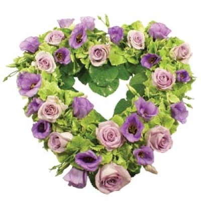 Lilac & Lavender Heart - One of our most beautiful and luxurious sympathy tributes in our range, this heart-shaped fresh flower wreath has been lovingly designed by our florists. Incorporating the palest lavender roses and masses of deep lilac lisianthus, this fresh flower tribute has a cushion of lime green hydraenga and waxy green galix leaves. Sending a floral heart tribute to a funeral makes a deeply personal statement and is indicative of the love and compassion felt by immediate family or the closely bereaved....