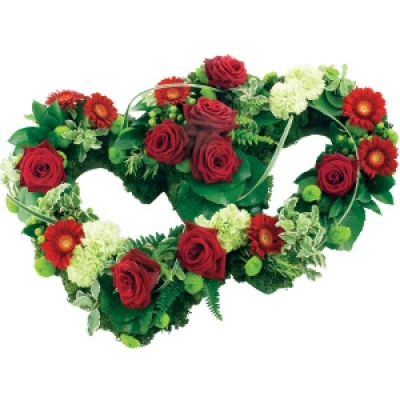 Eternal Heart - A beautiful twin heart tribute with red roses, red mini gerberas and mint green carnations, interspersed with seasonal foliage.