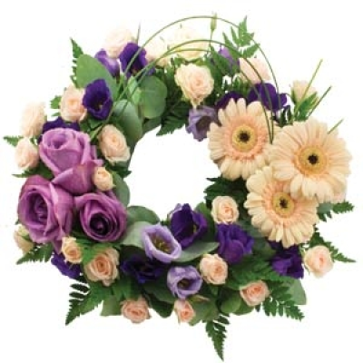 Contemporary Wreath - Beautiful cream gerberas and spray roses are arranged with lisianthus and seasonal blooms in this loose wreath arrangement. Small 14" £60.00 Medium 16" £75.00 Large 18" £00.00
