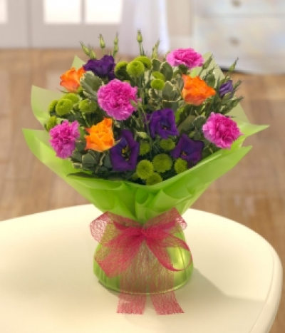 Painter's Palette - A bold and colourful mix of Roses and Carnations.  This beautiful bouquet will brighten somebody's day. Hand-Tie in water.