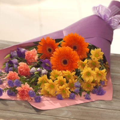 Summer Love - A summer carousel of colour. This bouquet is designed for someone who loves to arrange their own flowers. The feature flowers are Gerbera and Carnations accompanied by Lisianthus, Chrysanthemum and September flowers.