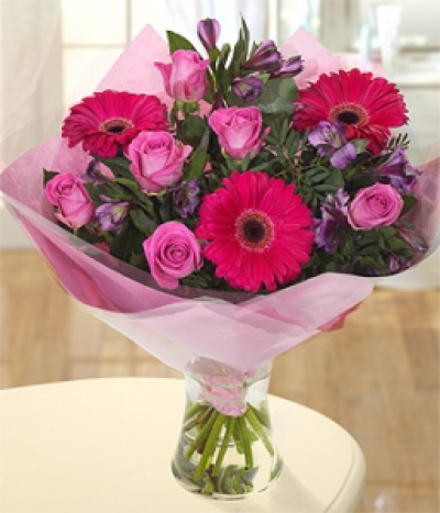 Pink Lady - A gorgeous hot pink mix of Gerberas, Roses and purple Alstroemeria. Hand-Tie in water.