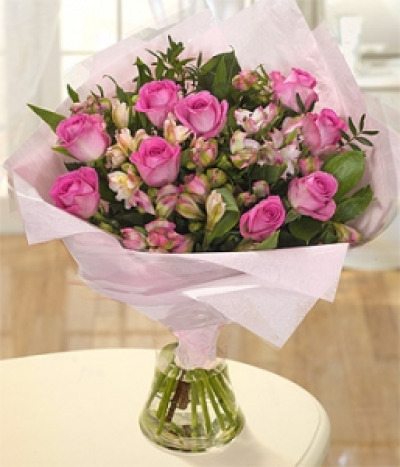 Ophelia - Beautiful pink Roses are combined perfectly with pink Alstroemeria offset with a dash of Ruscus and Pistache. Hand-Tie in water.