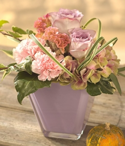 Autumn Mist - A pretty pink and mauve flower arrangement. Roses, Celosia, Hydrangea and Carnations in a lilac glass vase.