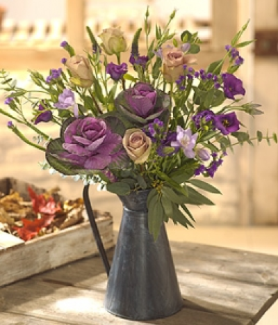 Midnight - A dramatic black zinc jug flower arrangement of deep plum purples and delicate lilacs. Roses, Freesia, Lisianthus, Statice and Brassica. (Vase not included).
