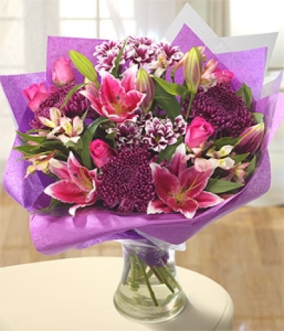 Happyness - A stunning, rich combination of pink Alstroemeria and Roses, purple Chrysanthemums and gorgeous Cobra Lilies