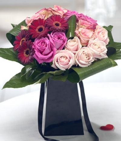 My Darling - A luxurious bouquet featuring pink Roses, complemented perfectly by deep red velvety Germini. Striking Aspidistra and Aralia leaves complete this exquisite arrangement.