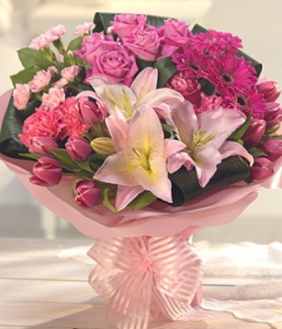 Lovely Lady - A stunning pink aqua pack flower bouquet that is sure to delight the senses. Beautifully fragrant pale pink Roses and Lilies sit perfectly with cerise Geminis and Tulips. Exquisity gift wrapped.