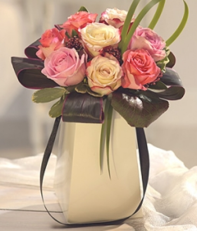 Sweet Treats - A divine and delicately fragrant combination of cream pink and raspberry Roses mixed with Skimmia Berries. Dramatic foliage perfects this delectable flower arrangement.