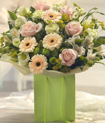 Gracious - A delightfully delicate flower gift bag bouquet. Pretty pink Roses are neatly nestled alongside pure white Alstroemeria and Lisianthus. Peach Germini, green Chrysanthemums and Carnations complete this fragrant gift.