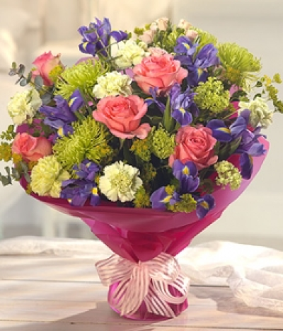 Young at Heart - Pretty pink Roses and Irises have been beautifully combined with green Bloom Chrysanthemums and Carnations to create this simply gorgeous and delicately fragrant aqua pack bouquet.
