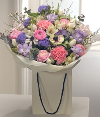 Sweetly Scented - A fantastically fragrant aqua pack gift bag bouquet in delicate springtime pastel shades. Pink Hyacinth, Carnations and Ranunculus are married with white Alstromeria, Ageratum, Anemone and Tulips. Lavender Freesias complete the arrangement.